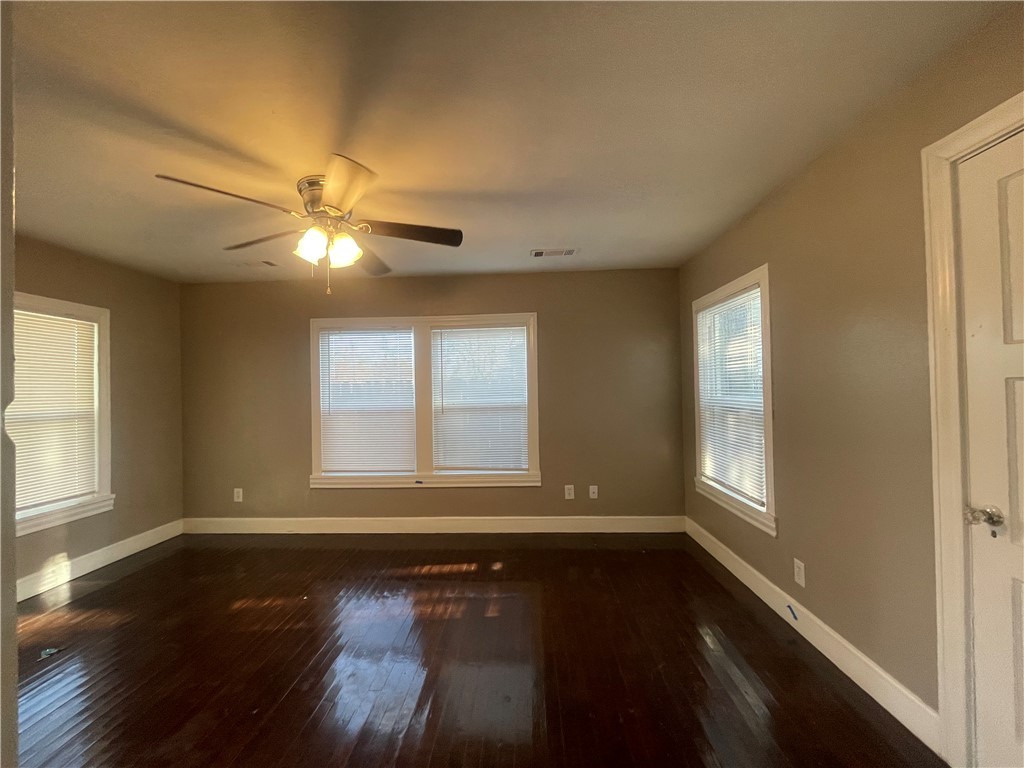 1900 Echols Street, Unit B Bryan, TX 77801 - Photo 2 of 9 a view of an empty room with wooden floor and a window