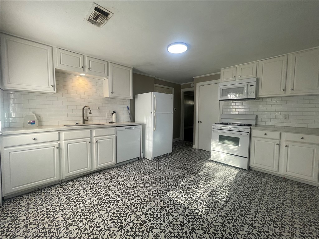 1900 Echols Street, Unit B Bryan, TX 77801 - Photo 4 of 9 a kitchen with a sink cabinets and appliances