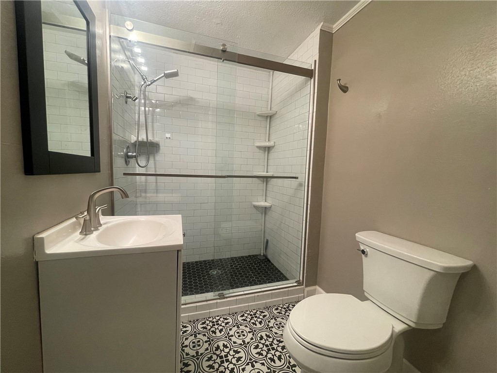 1900 Echols Street, Unit B Bryan, TX 77801 - Photo 6 of 9 a bathroom with a sink toilet and shower