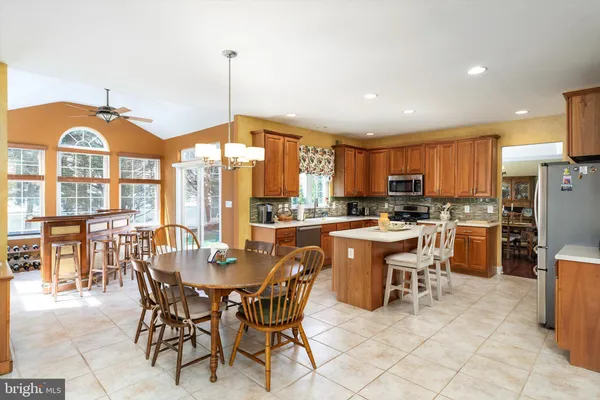 a large kitchen with a table and chairs