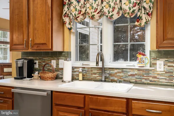 a dining hall with stainless steel appliances granite countertop a table and chairs