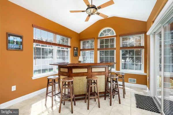 a living room with furniture large window and a fireplace