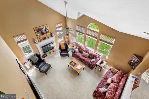 a living room with furniture a window and a lamp