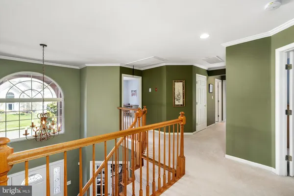 a bedroom with a bed and dresser with mirror