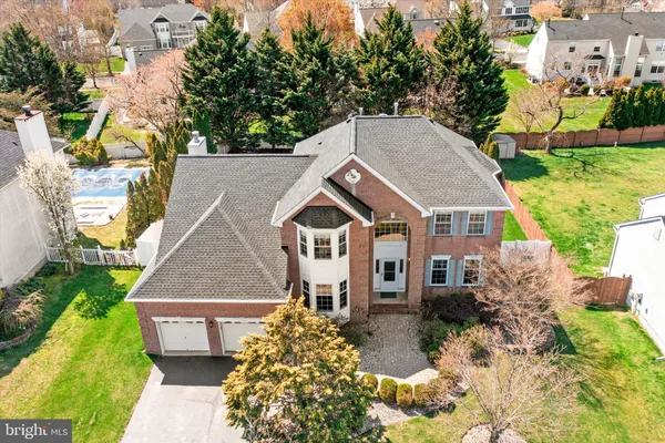 a aerial view of a house with a yard and potted plants