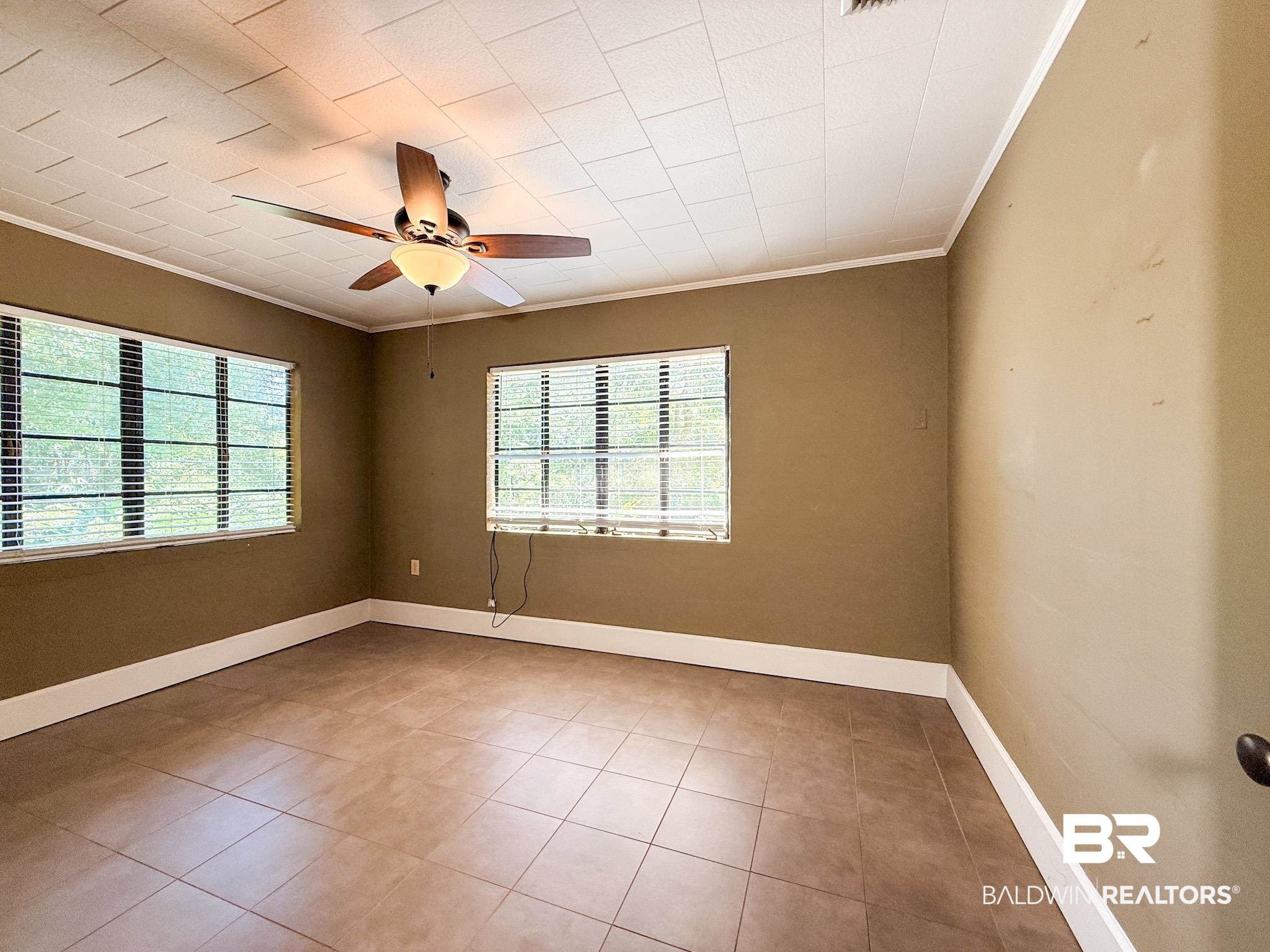 18711 Keller Road Foley, AL 36535 - Photo 15 of 38 Room featuring two windows with blinds, a ceiling fan with integrated lighting, and tile flooring