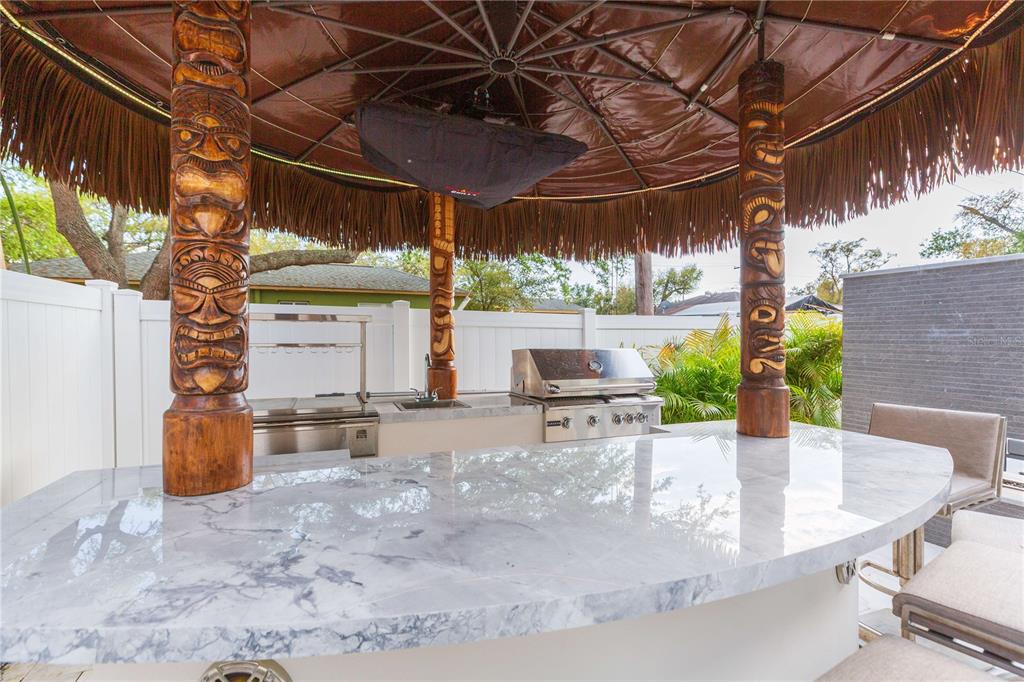 1304 West Arch Street Tampa, FL 33607 - Photo 15 of 75 a view of a patio with a table and chairs and potted plants