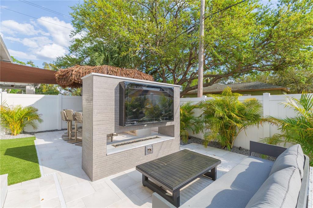 1304 West Arch Street Tampa, FL 33607 - Photo 18 of 75 a view of a backyard with plants and a patio