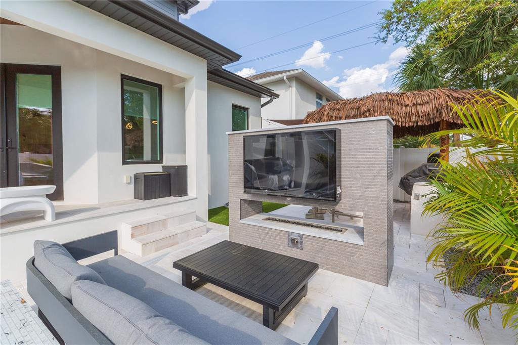 1304 West Arch Street Tampa, FL 33607 - Photo 19 of 75 a view of living room kitchen with stainless steel appliances granite countertop couches and table next to white wooden fence