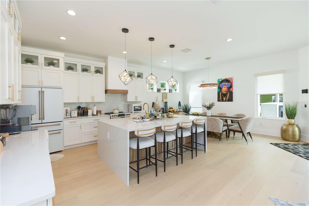 1304 West Arch Street Tampa, FL 33607 - Photo 21 of 75 a large white kitchen with lots of furniture a sink appliances and a dining table
