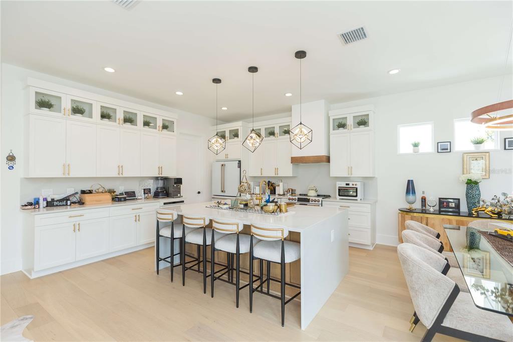 1304 West Arch Street Tampa, FL 33607 - Photo 23 of 75 a kitchen with a stove a sink a dining table and chairs