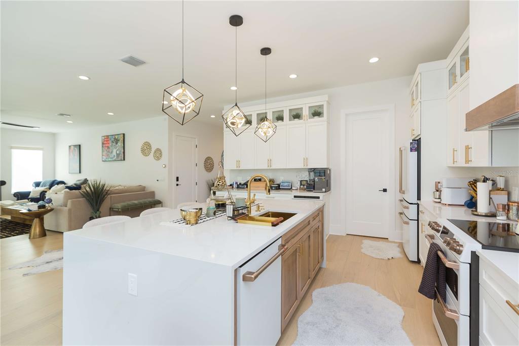 1304 West Arch Street Tampa, FL 33607 - Photo 27 of 75 a kitchen that has a lot of white cabinets and stainless steel appliances