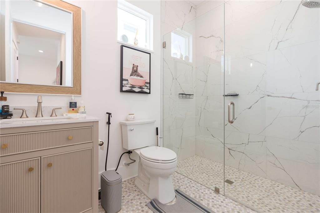 1304 West Arch Street Tampa, FL 33607 - Photo 38 of 75 a bathroom with a sink toilet vanity and shower