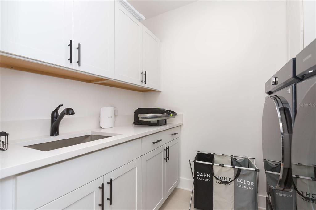 1304 West Arch Street Tampa, FL 33607 - Photo 46 of 75 a kitchen with a sink stainless steel appliances and cabinets