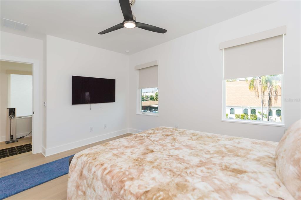 1304 West Arch Street Tampa, FL 33607 - Photo 50 of 75 a bedroom with a bed and a flat screen tv