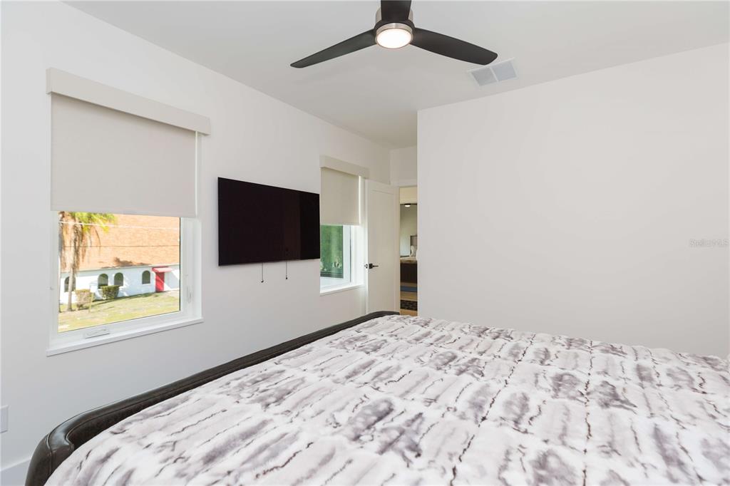 1304 West Arch Street Tampa, FL 33607 - Photo 54 of 75 a bedroom with a bed and a flat screen tv