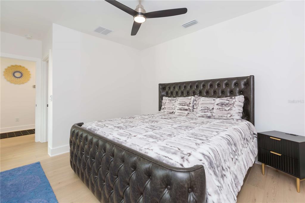 1304 West Arch Street Tampa, FL 33607 - Photo 55 of 75 a bed sitting in a bedroom next to a window with wooden floor