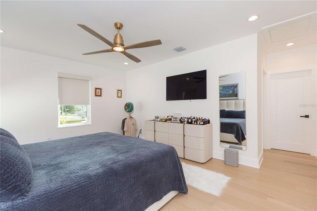 1304 West Arch Street Tampa, FL 33607 - Photo 61 of 75 a spacious bedroom with a bed and a flat screen tv