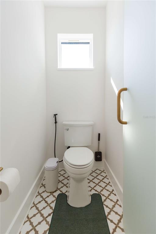 1304 West Arch Street Tampa, FL 33607 - Photo 69 of 75 a white toilet sitting next to a white sink