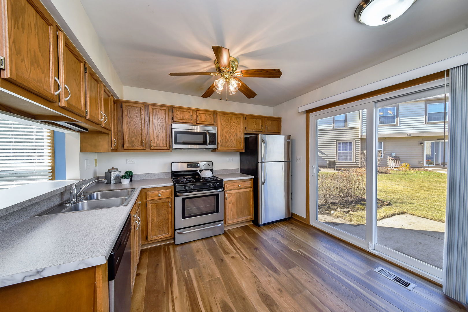1266 Seabury Circle Carol Stream, IL 60188 - Photo 8 of 22 a kitchen with stainless steel appliances granite countertop a stove top oven a refrigerator a sink and dishwasher with wooden floor