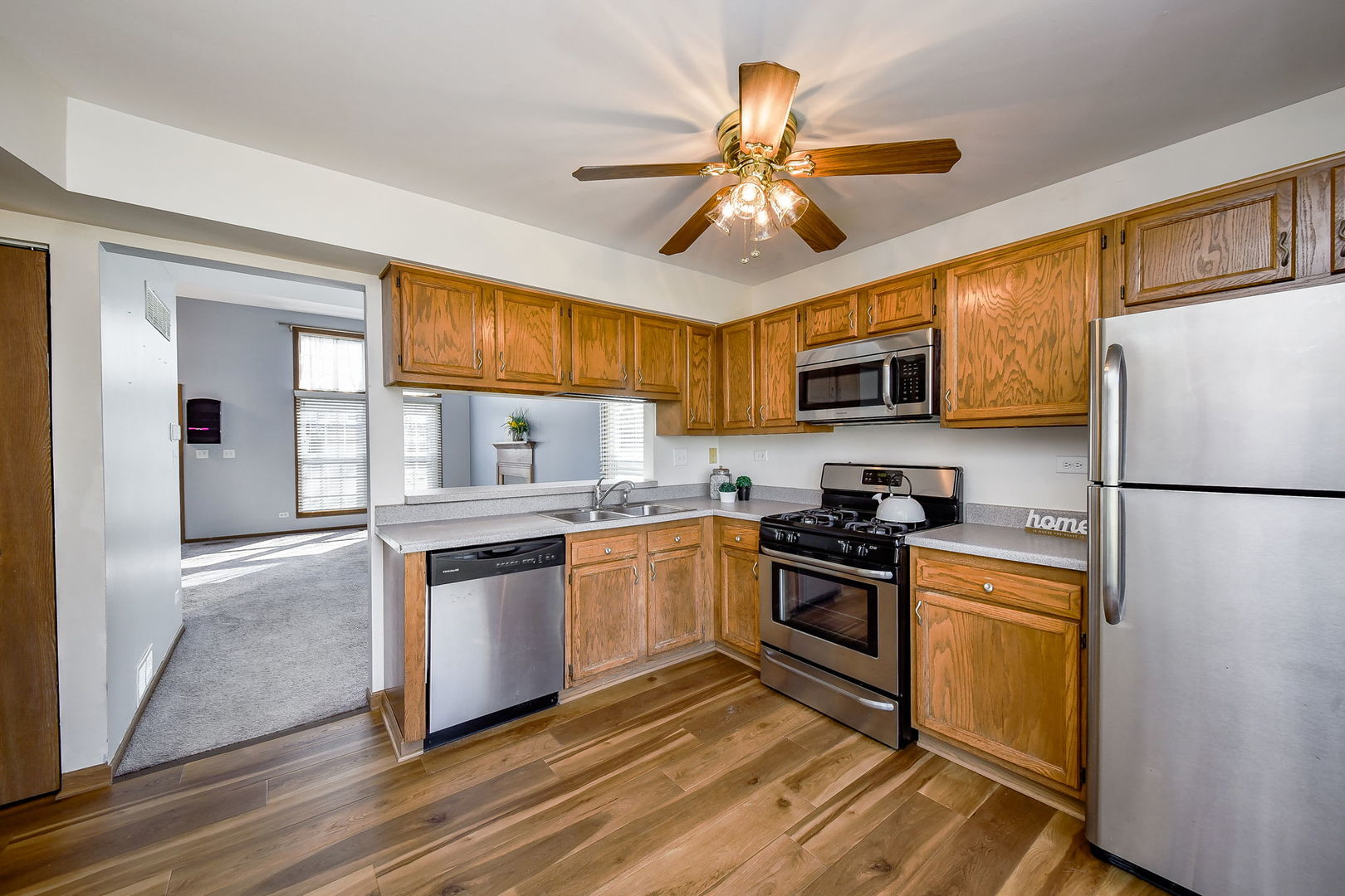 1266 Seabury Circle Carol Stream, IL 60188 - Photo 9 of 22 a kitchen with stainless steel appliances granite countertop a stove top oven a refrigerator a sink and dishwasher with wooden floor