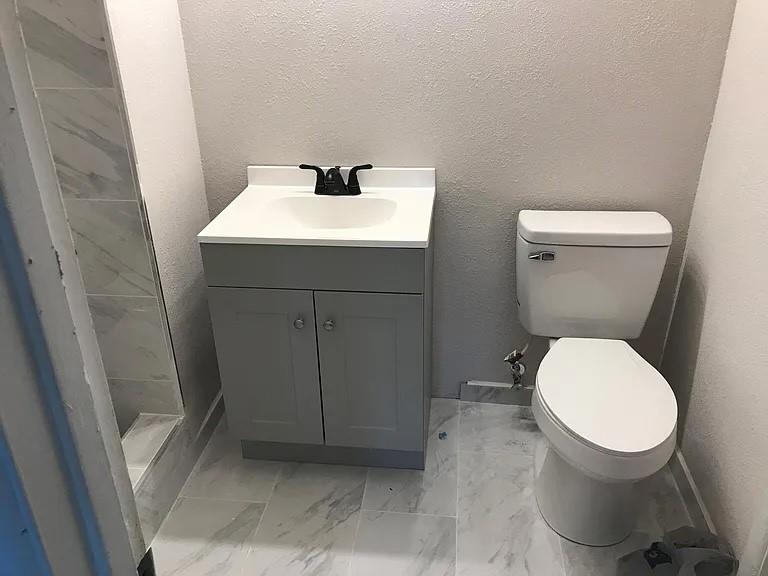 1617 East Union Bower Road Irving, TX 75061 - Photo 7 of 14 a bathroom with a toilet sink and mirror