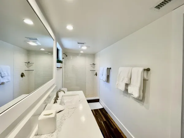 a bathroom with a sink and glass door