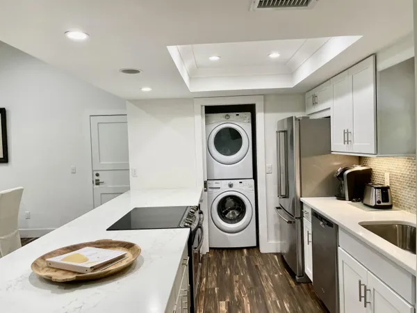 a kitchen with a sink a stove and cabinets