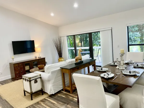 a view of a workspace with furniture and a large window