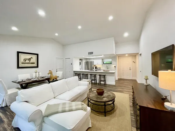a spacious bedroom with a bed and wooden floor