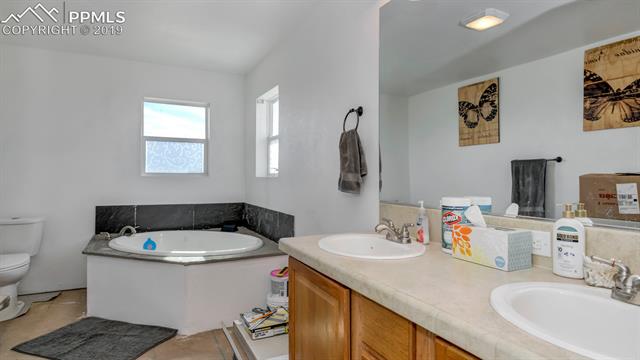 755 Edison Road Yoder, CO 80864 - Photo 15 of 29 This 5 piece master bath offers a double sinks with plenty of cabinet space-Jetted Tub-Stand alone Shower and water saving toilet-