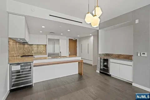 a kitchen with stainless steel appliances granite countertop a stove and white cabinets