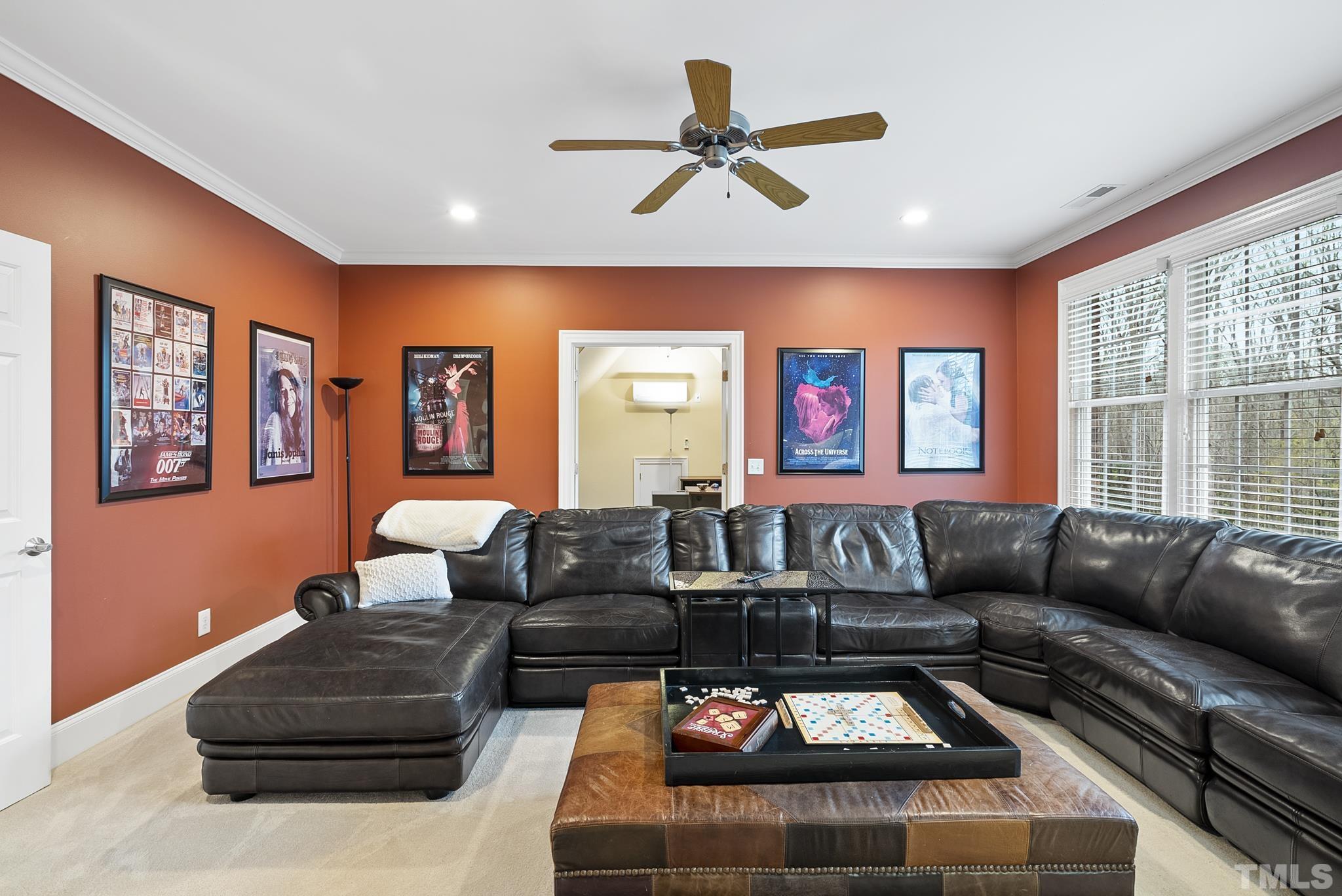 2512 Hunters Meadow Lane Raleigh, NC 27606 - Photo 54 of 86 a living room with furniture a rug and a large window