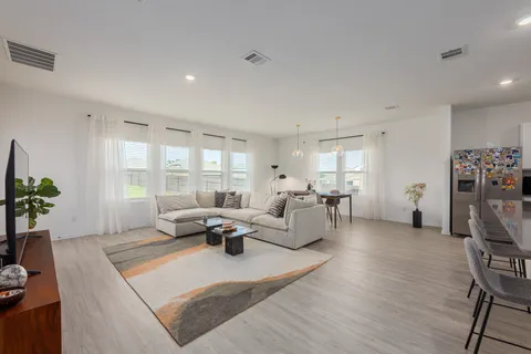 a living room with furniture window and wooden floor