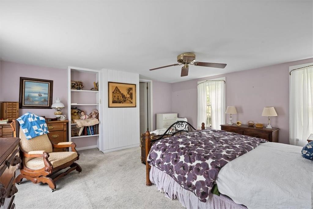 870 Field Club Road Pittsburgh, PA 15238 - Photo 9 of 19 a bedroom with a large bed and a chandelier