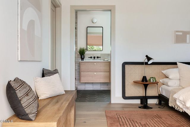 a bedroom with furniture and a mirror