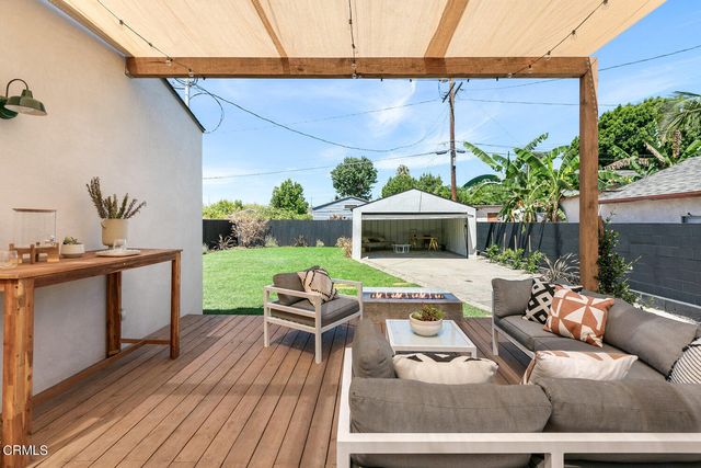 a outdoor living space with furniture and a fireplace