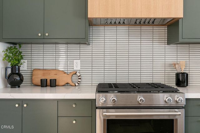 a kitchen with a stove and cabinets