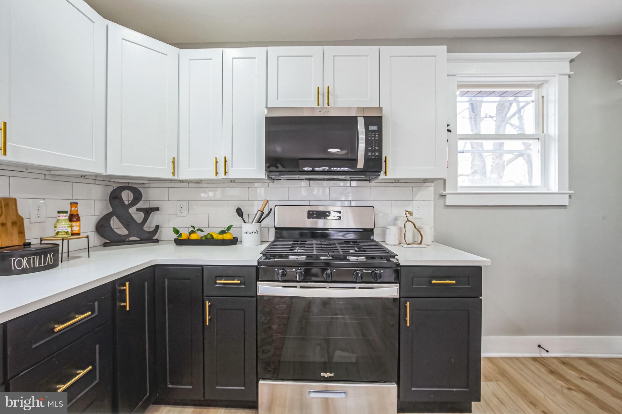 409 Neck Road Burlington, NJ 08016 - Photo 11 of 27 a kitchen with stainless steel appliances granite countertop a stove a sink and a microwave