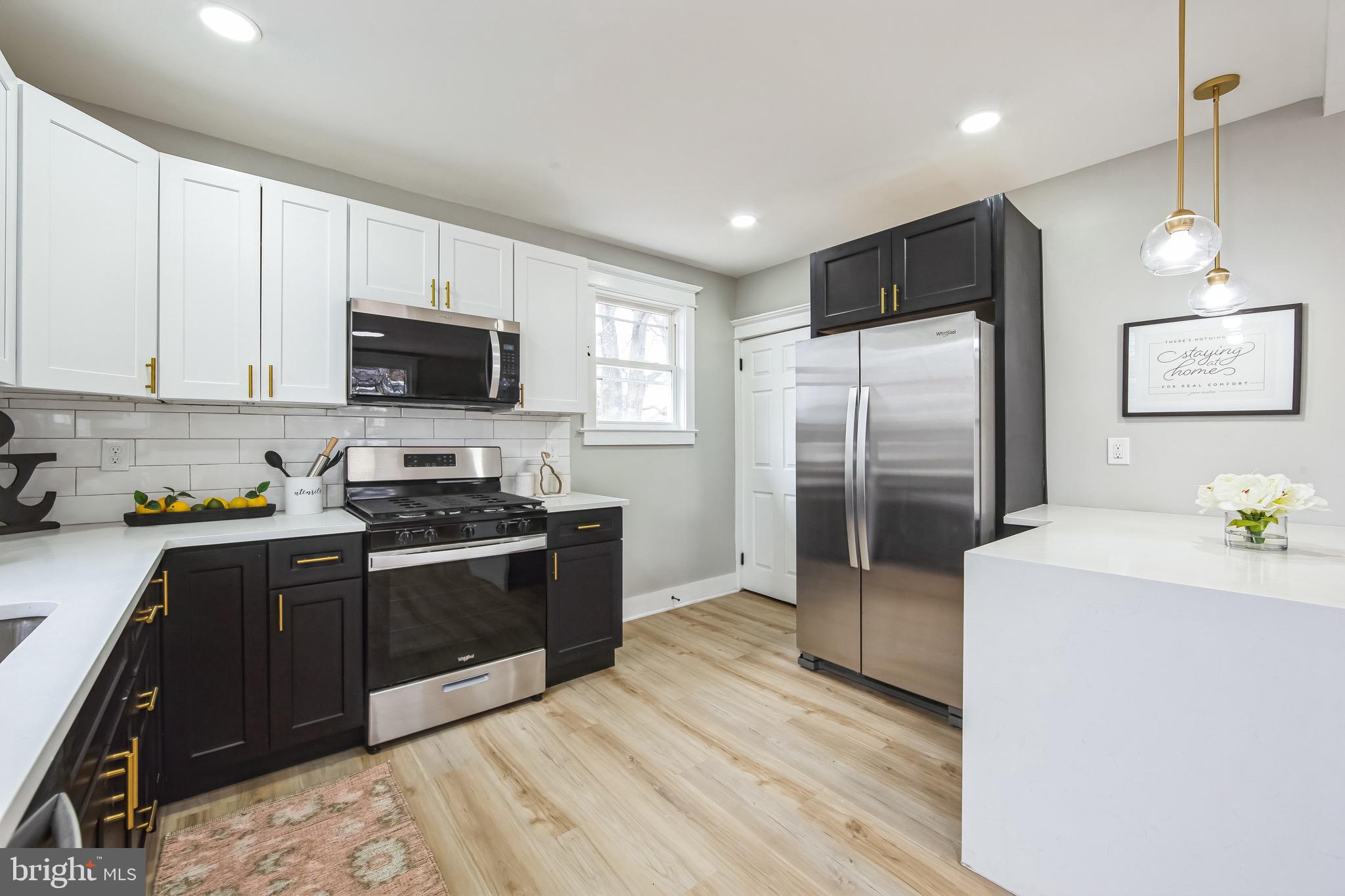 409 Neck Road Burlington, NJ 08016 - Photo 12 of 27 a kitchen with stainless steel appliances granite countertop a refrigerator stove top oven and sink
