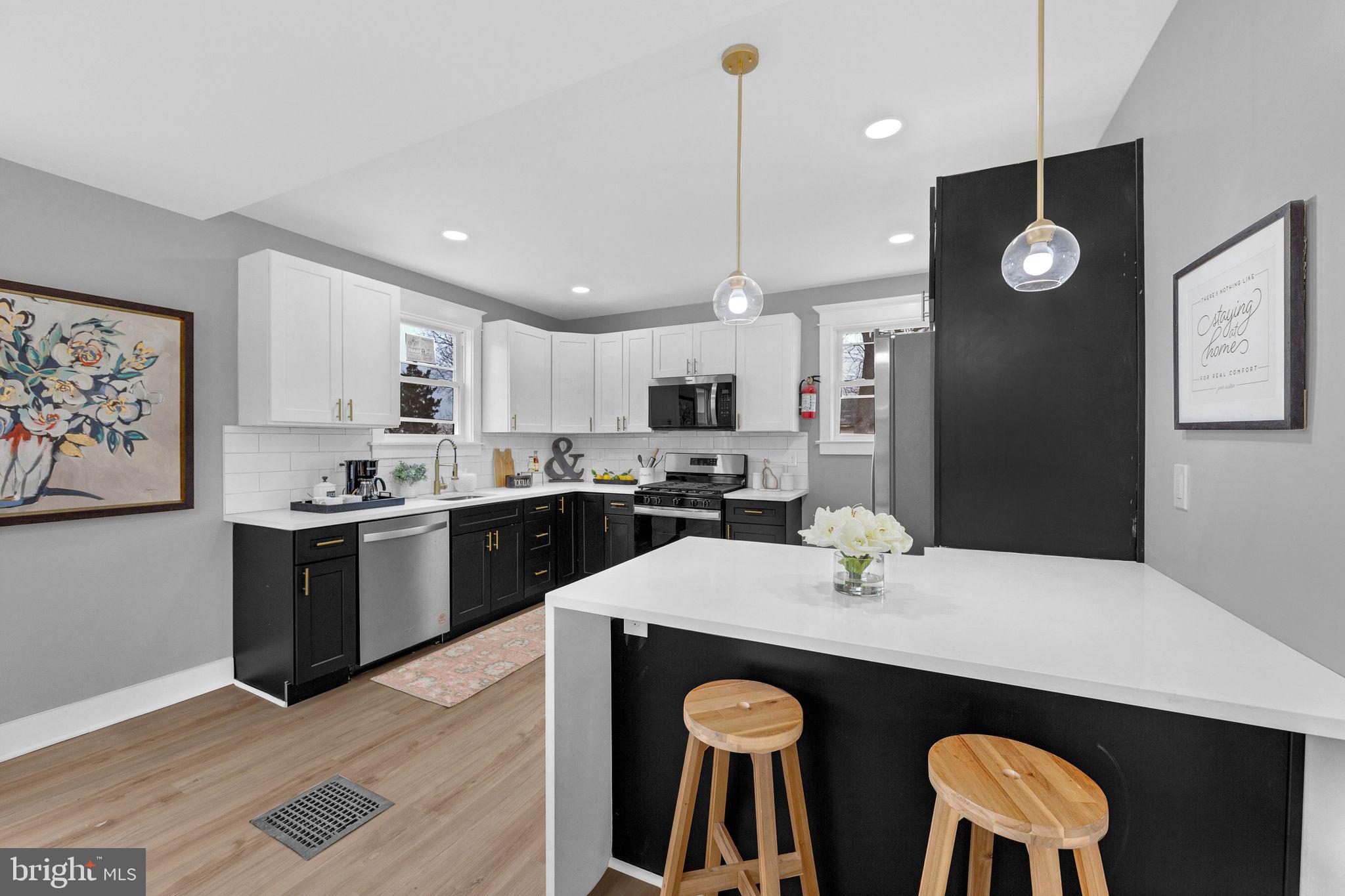 409 Neck Road Burlington, NJ 08016 - Photo 13 of 27 a kitchen with stainless steel appliances granite countertop a sink a stove a refrigerator a dining table and chairs