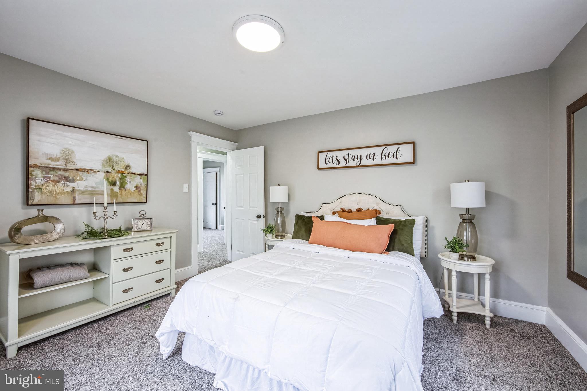 409 Neck Road Burlington, NJ 08016 - Photo 18 of 27 a bedroom with a bed and a painting on the wall