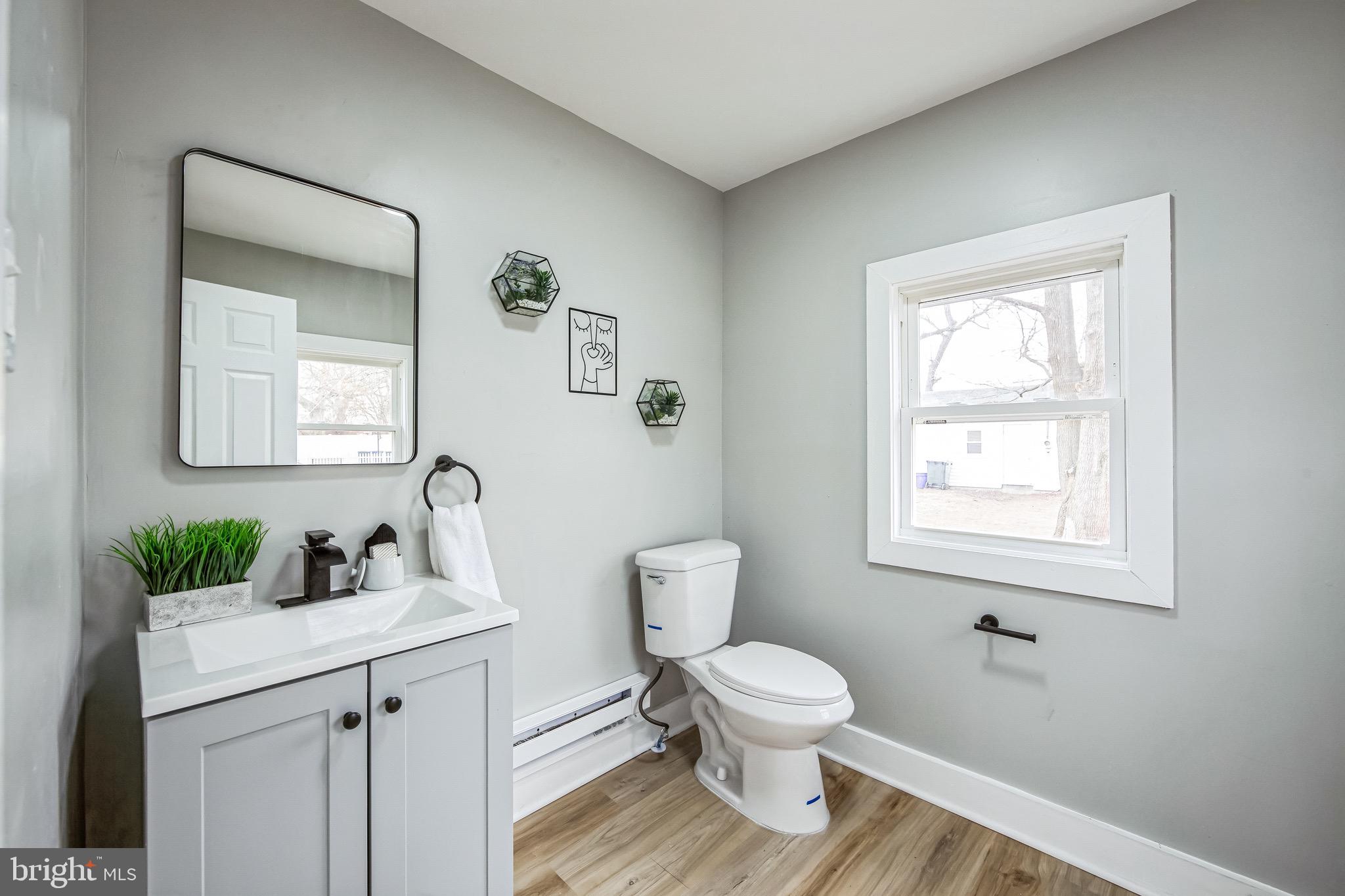 409 Neck Road Burlington, NJ 08016 - Photo 23 of 27 a bathroom with a toilet sink and mirror