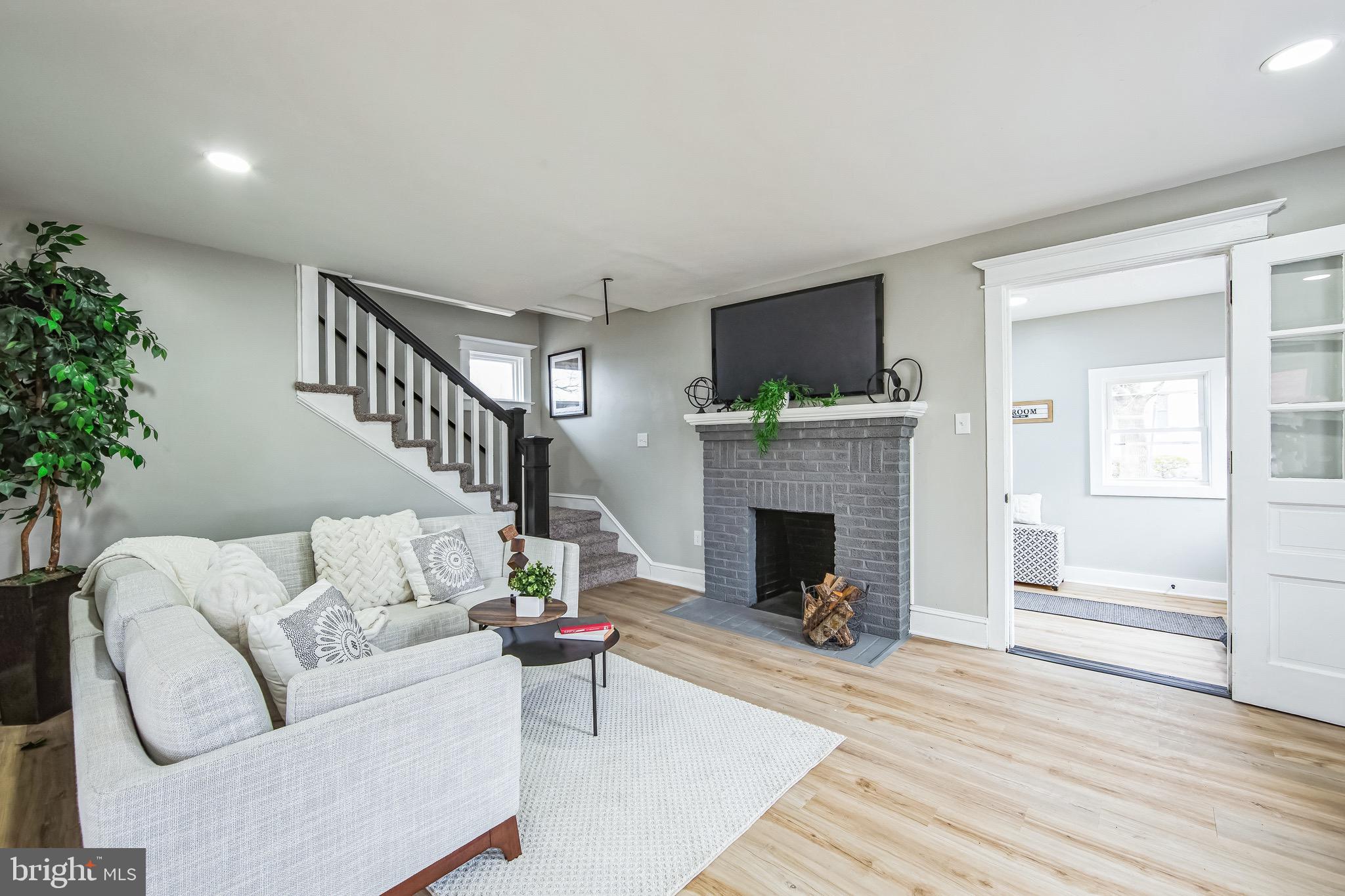 409 Neck Road Burlington, NJ 08016 - Photo 6 of 27 a living room with furniture a fireplace and a potted plant