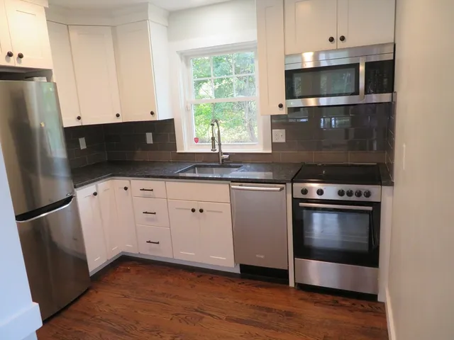 a kitchen with a sink and a microwave