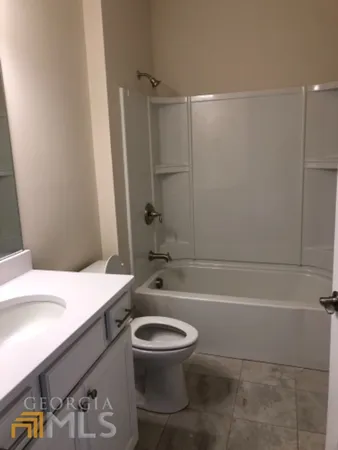 a bathroom with a sink a toilet and a bathtub