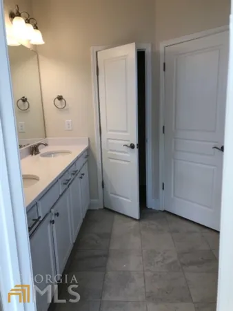 a bathroom with a double vanity sink and a mirror