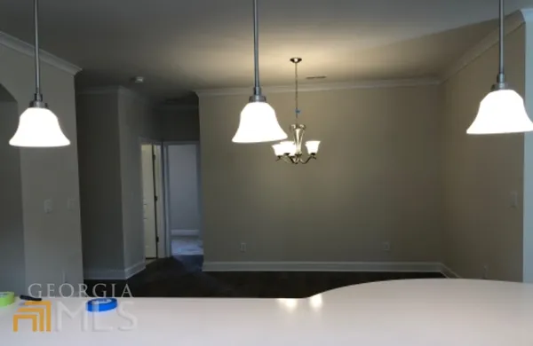 a view of a chandelier fan and kitchen view