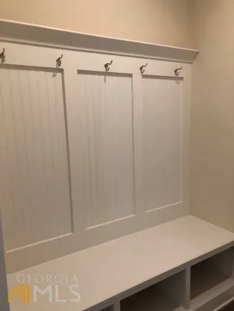a bathroom with a shower and a wooden floor