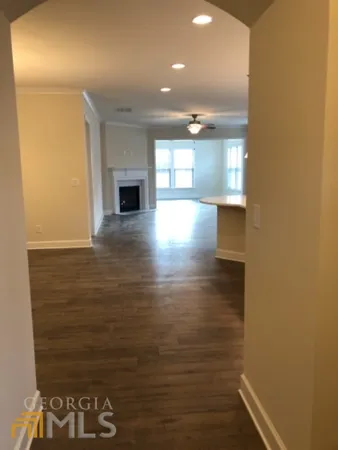 an empty room with wooden floor and a window